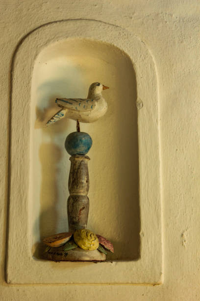 Typical craft ornament: an wood dove in a wall niche.