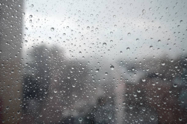 istock Drops of rain on the window, rainy day 894446110