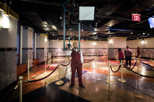 NEW YORK, USA - October 17, 2016. Employee Taking Tourists in pictures on Arrival inside the Empire State Building.