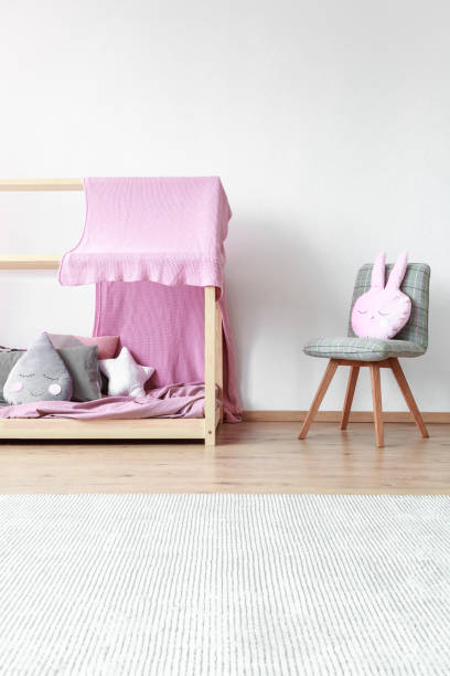 istock Bright baby's bedroom with chair 894456706