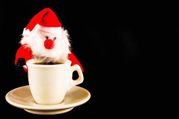 istock black coffee in a white cup and plush Santa Claus, drink set 894456758
