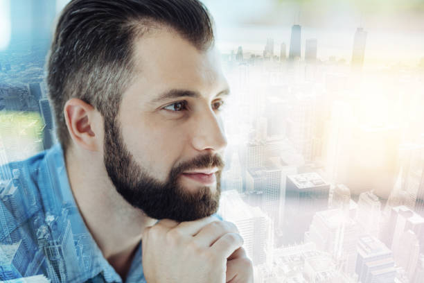 istock Handsome thoughtful man holding close hands and looking aside 894457930