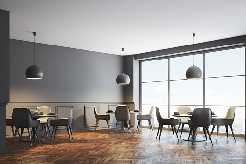 Gray cafe corner with a wooden floor, round tables and gray chairs near them. 3d rendering mock up
