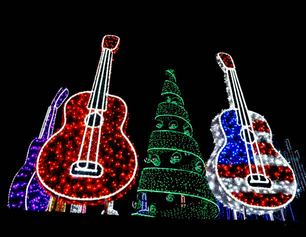 AUSTIN, TEXAS USA- DECEMBER 11, 2017: Bright Red, Red White and Blue USA Flag Guitar and a Red Guitar with lights and a Green Holiday Tree with Ornaments lit up with Lights at Mozart's Coffee Roasters Holiday Light Show on Lake Austin