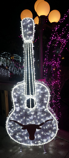 AUSTIN, TEXAS USA- DECEMBER 11, 2017: A Guitar with a silhouette of the face of a Longhorn lit up with white Holiday Lights at Mozart's Coffee Roasters Holiday Light Show on Lake Austin