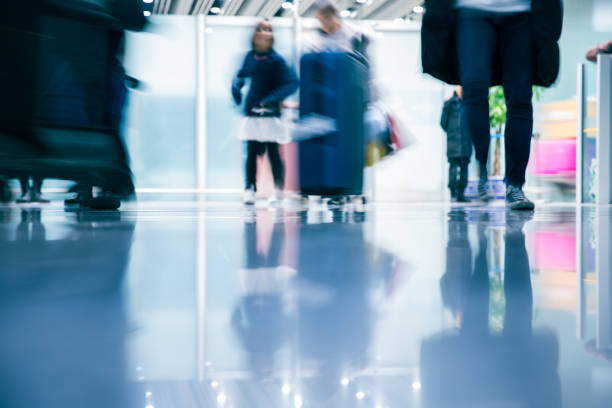 istock People walking in modern airport 894465152