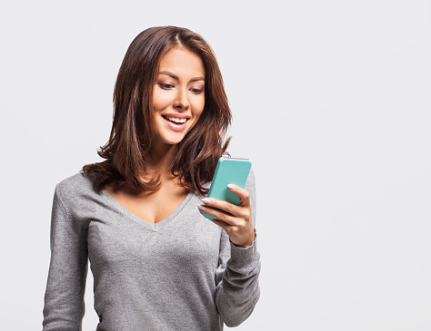 Laughing woman holding smart phone