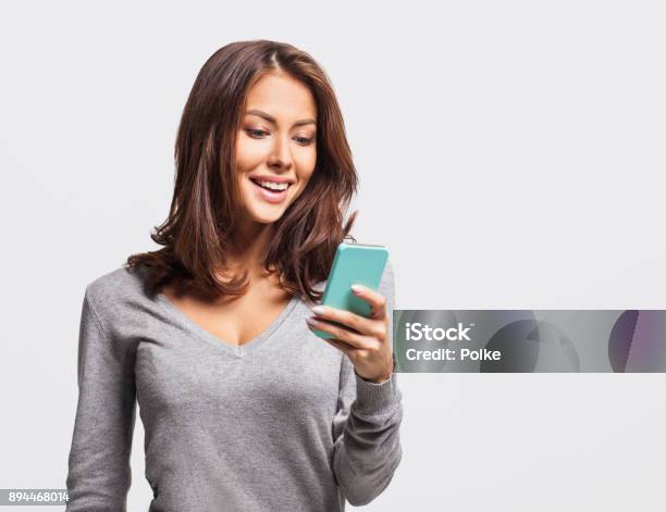 Happy Young Girl Using Smart Phone Stock Photo - Download Image Now - Women, One Woman Only, Mobile Phone