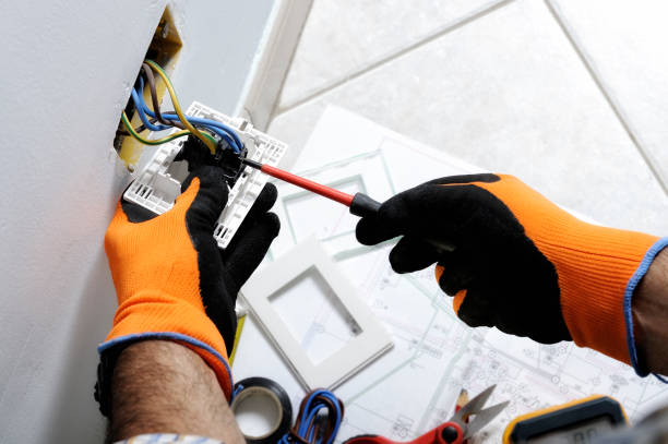 Electrician working in a residential electrical system Electrician working safely on switches and sockets of a residential electrical system glove stock pictures, royalty-free photos & images