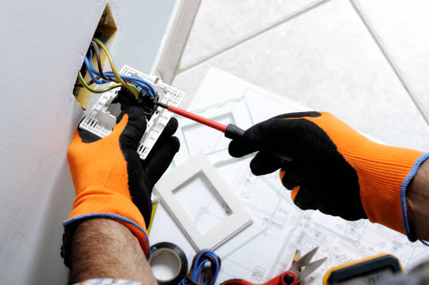 Electrician working in a residential electrical system Electrician working safely on switches and sockets of a residential electrical system protective glove stock pictures, royalty-free photos & images