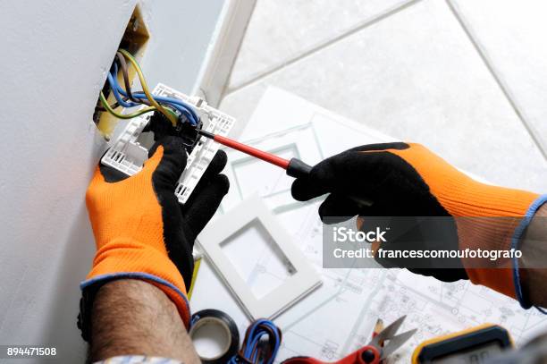 Electrician Working In A Residential Electrical System Stock Photo - Download Image Now