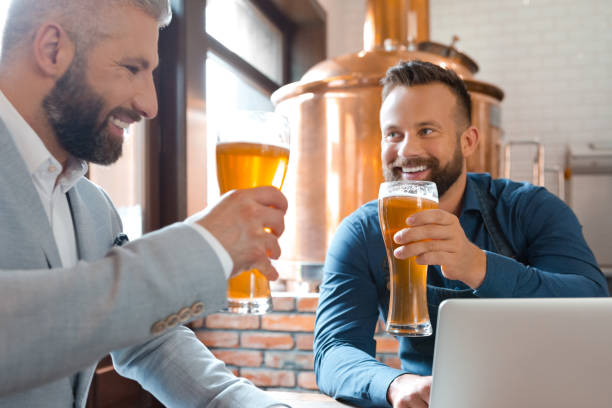 istock Master brewer and businessman having beers in brewery 894472488