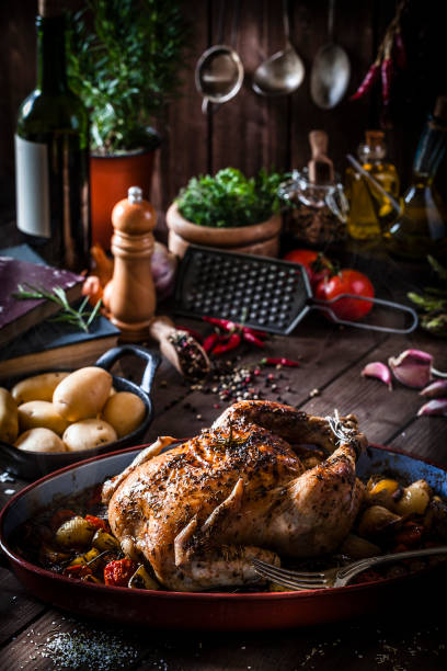 istock Baked chicken with vegetables on rustic wooden table 894476598