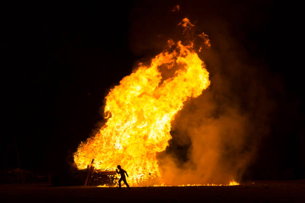 istock Runner silhouette in front of a large bonfire 894481722