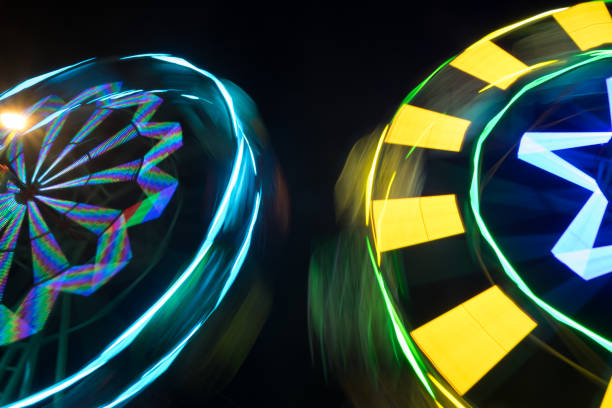 istock Ferris wheel with neon light at night carnival park 894504382