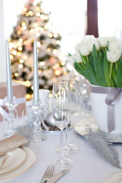 istock Elegant dining table and Christmas tree in living room 894504400