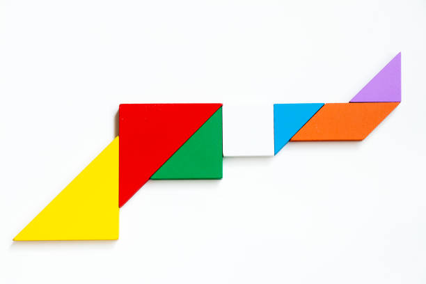istock Colorful wood tangram puzzle in gun shape on white background 894505590