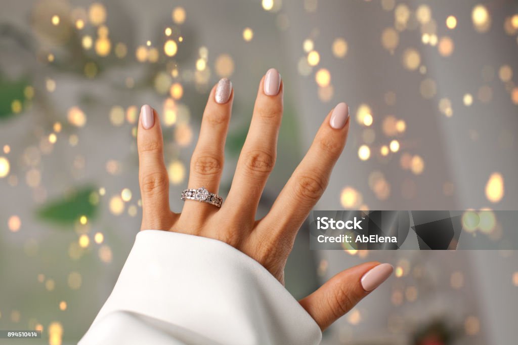 Diamond ring on a finger. Beautiful Diamond ring on a finger. Holidays and celebrations concept. Engagement Ring Stock Photo