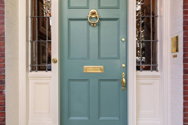 Front door, turquoise colored with brass plated fixtures Front Turquoise door that is secured featuring a white trim blue front door stock pictures, royalty-free photos & images