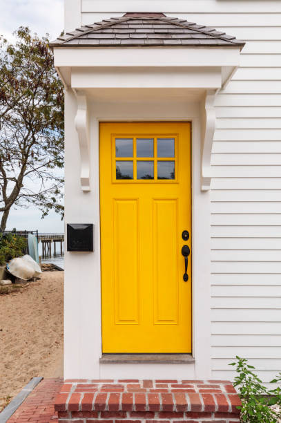 Front yellow door of a house by the seaside stock photo