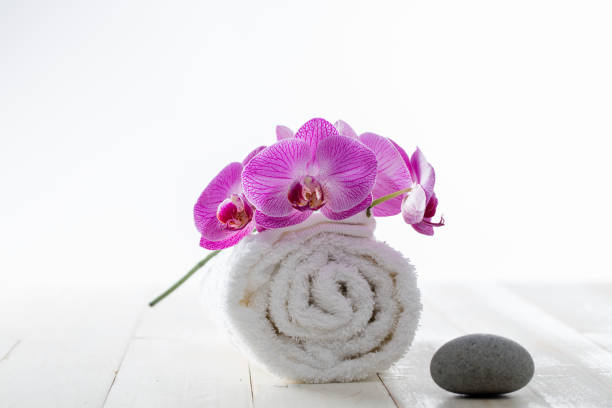 istock pure white towel with limestone pebble for concept of softness 894527666