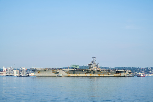 Bremerton, WA USA Dec. 10, 2017: US Navy aircraft carrier USS Nimitz (CVN 68) returns to Naval Base Kitsap for some much needed repairs and maintenance after a six month deployment to the middle east and western pacific regions.