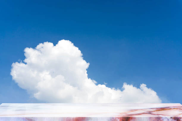 istock Empty top of natural stone table and sky background. For product display. 894541036