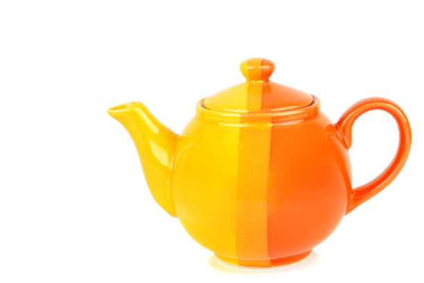 istock Orange color porcelain teapot, isolated on white background. Free space for text. 894555970
