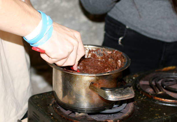 istock A man is cooking chocolate in a saucepan. Stir with a spoon 894567964