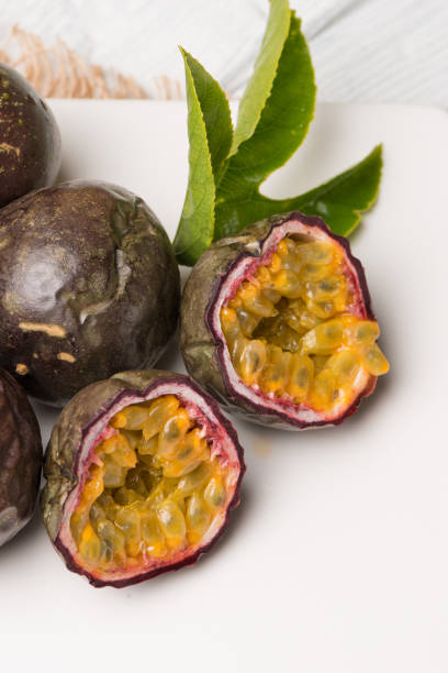 istock Passion fruits on white ceramic tray on wooden table background. 894586178