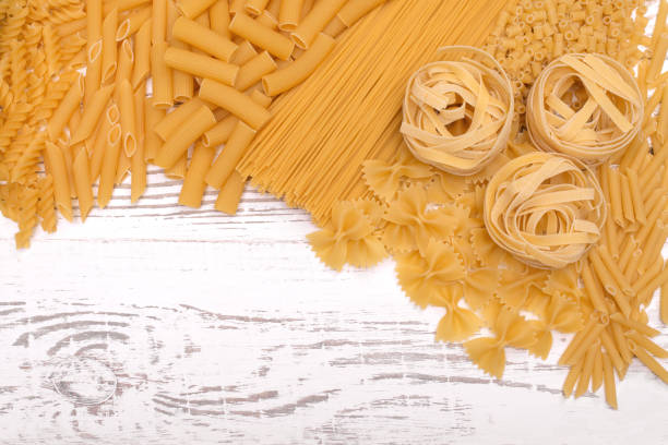 istock Italian pasta types on wooden table 894586328