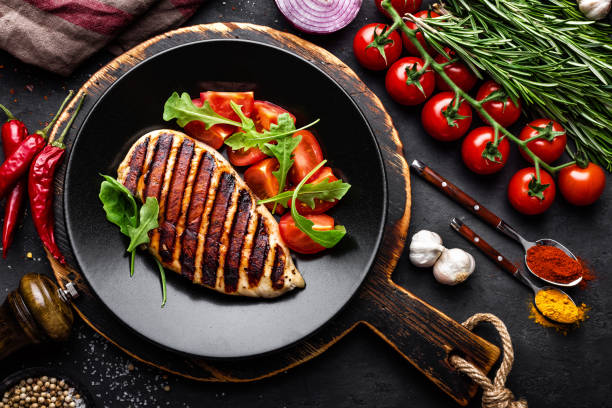 istock Grilled chicken fillet on black background. Top view 894588974
