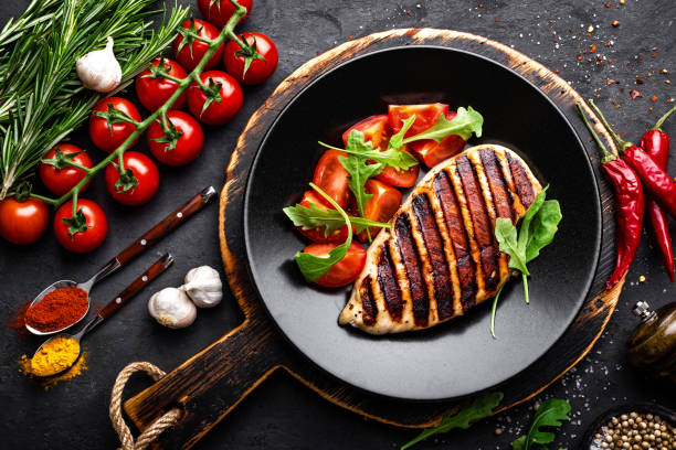 istock Grilled chicken fillet on black background. Top view 894589520