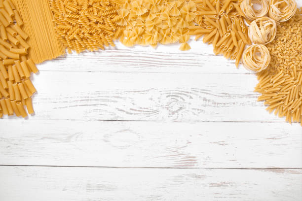 istock Italian pasta types on wooden table 894589816
