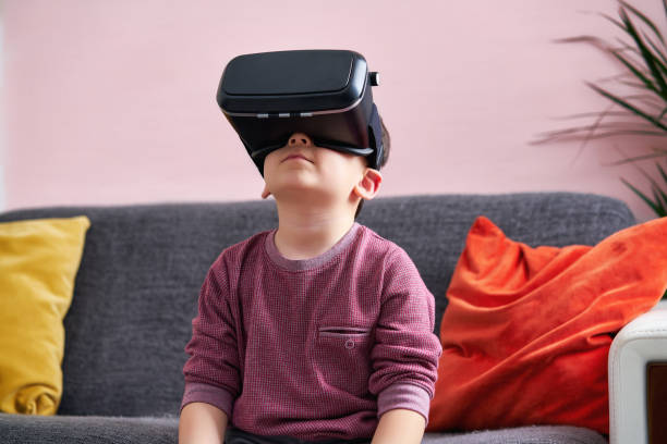 istock 4-5 years old cute child is wearing virtual reality glasses. 894589820