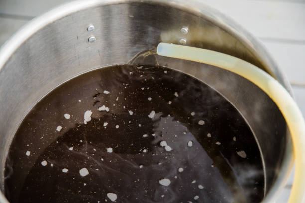 istock Pouring Craft Home Brew Beer Wort into the Boil Kettle 894596068