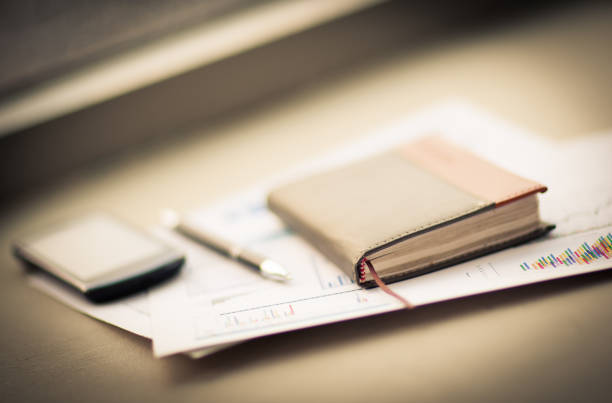 istock personal organizer and pen lie on documents on the desktop 894602232