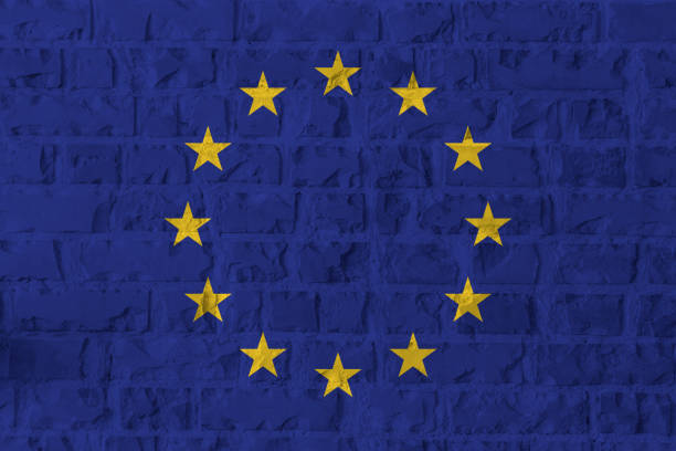 istock European Union flag on brick wall texture background. 894602364