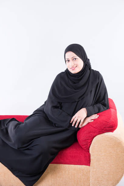 istock Arab woman sitting on sofa 894605862