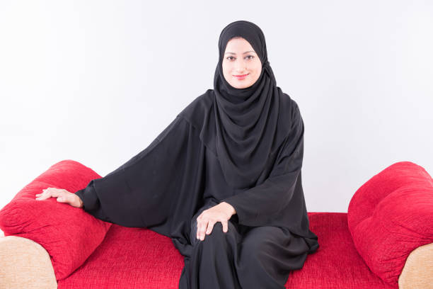 istock Arab woman sitting on sofa chair 894605966