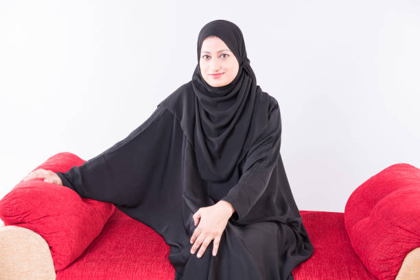 istock Arab woman sitting on sofa chair 894606046