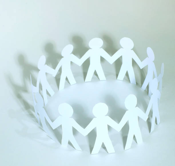 istock Team of paper doll people holding hands 894606050