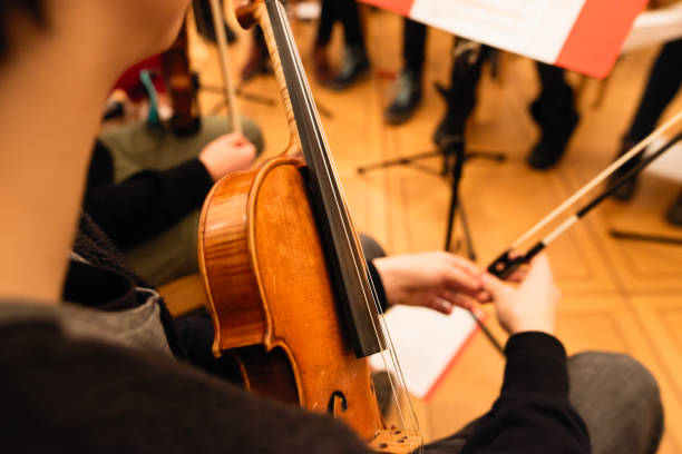 istock Playing violin in a youth orchestra 894618550