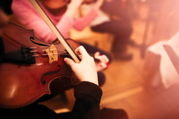 istock Playing violin in a youth orchestra 894620904