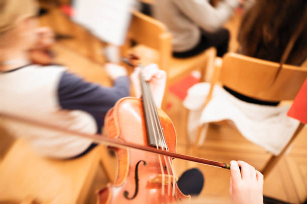 istock Playing violin in a youth orchestra 894620932