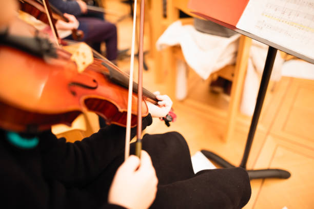 istock Playing violin in a youth orchestra 894620972