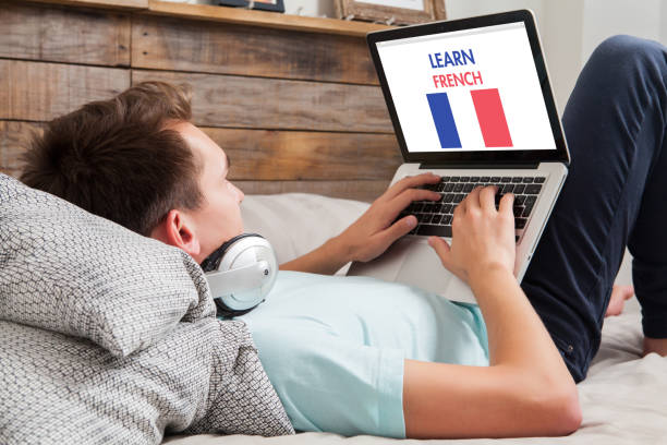 man learning french at home. - house home interior flag usa imagens e fotografias de stock