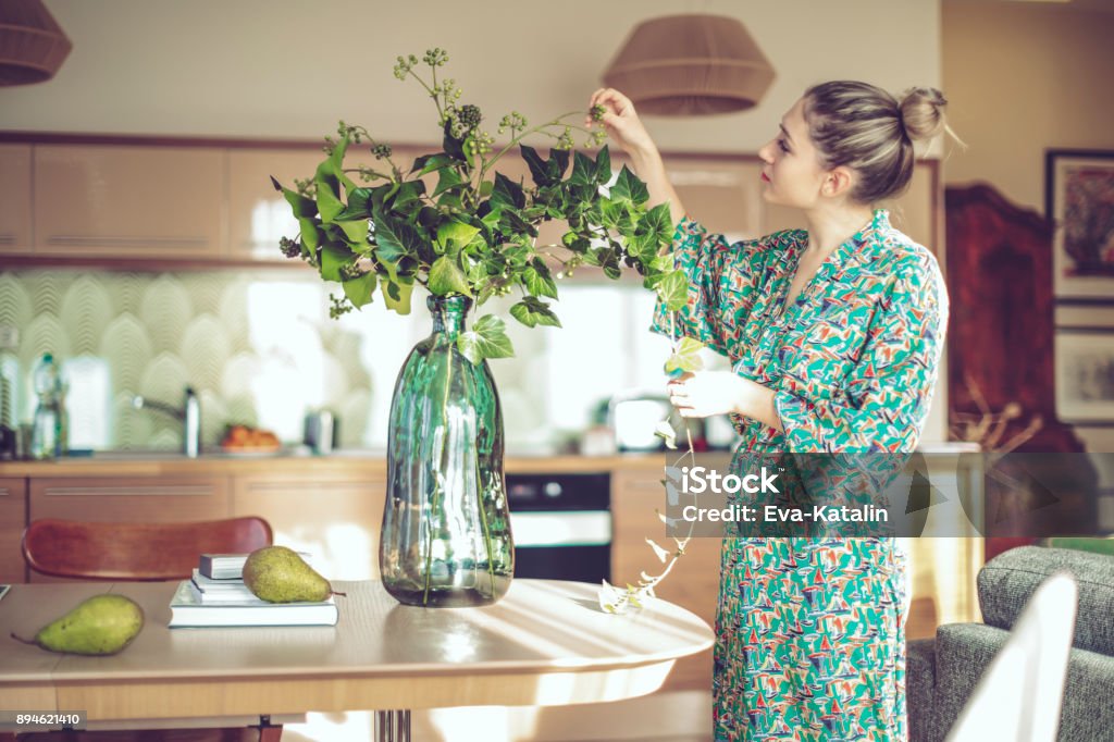 Young woman at home Flower Stock Photo