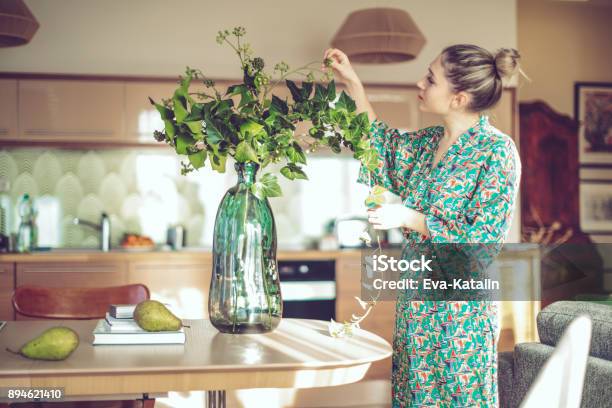 Young Woman At Home Stock Photo - Download Image Now - Flower, Domestic Life, Women