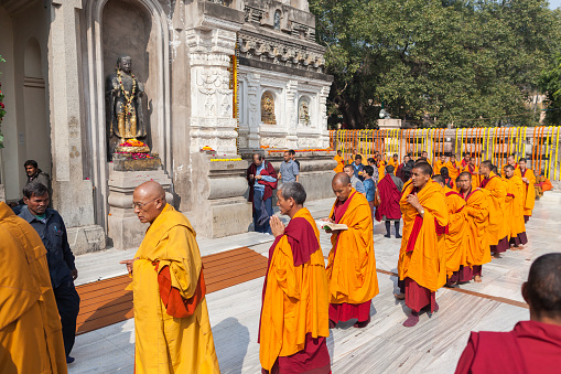 January 29, 2014. India. Bodh Gaya. Group of monks - pilgrims do kora (a traditional round of the temple, a stupa or other holy site) around Mahabodhi Temple, during an annual menlam.
